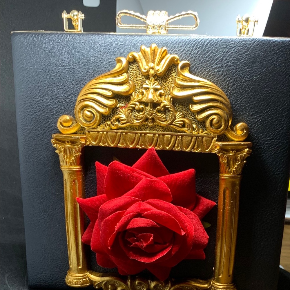Black handbag with red rose